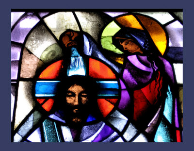 stained glass depicting Mary Magdalene annointing the head of Jesus